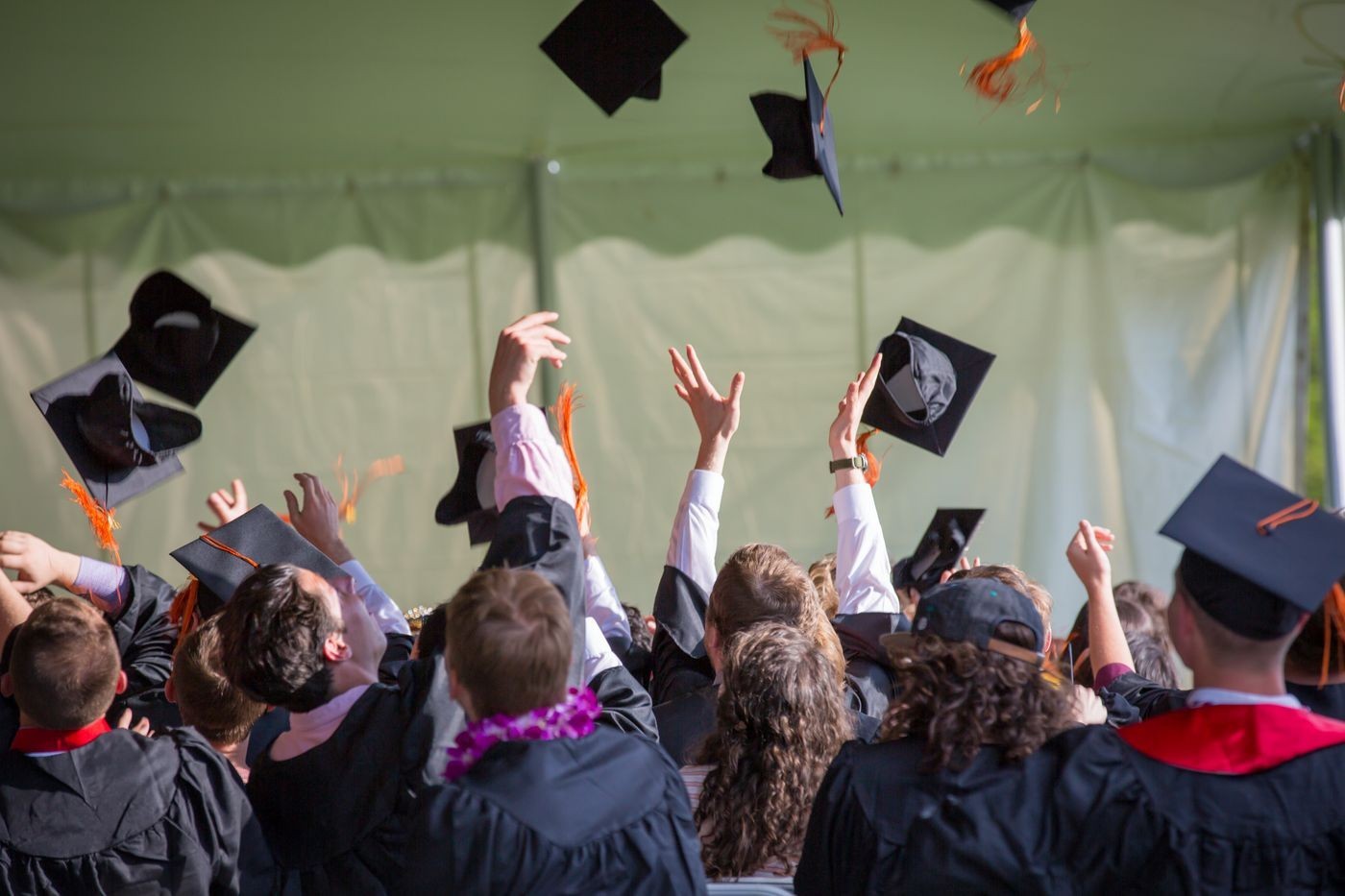 University graduates celebrating by tossing their caps